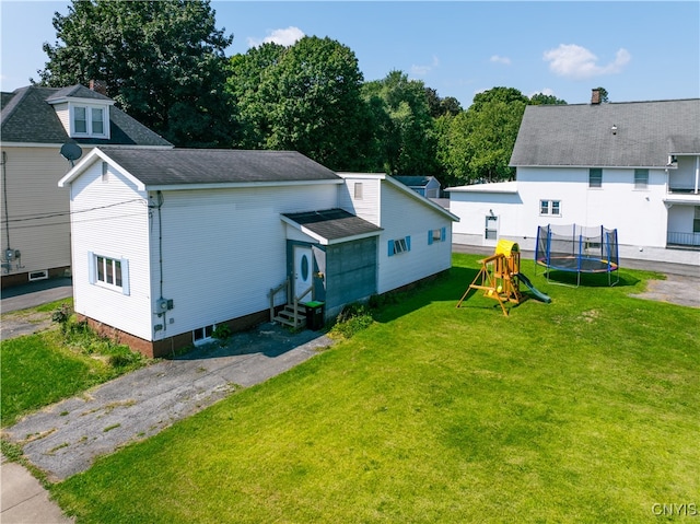 exterior space featuring entry steps, a trampoline, a front lawn, and a playground