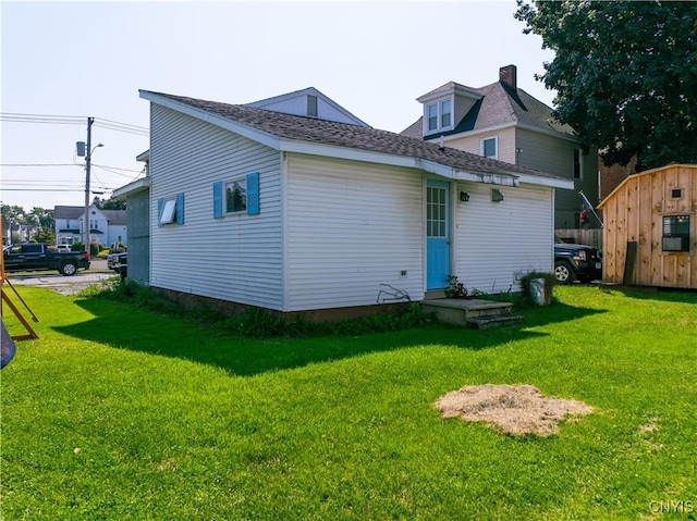 rear view of house featuring a lawn