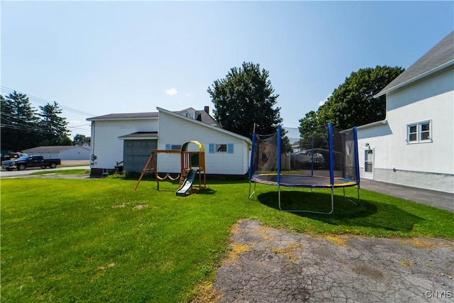 view of yard with a trampoline and a playground