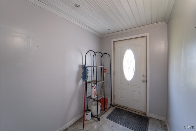 entrance foyer featuring concrete floors and ornamental molding