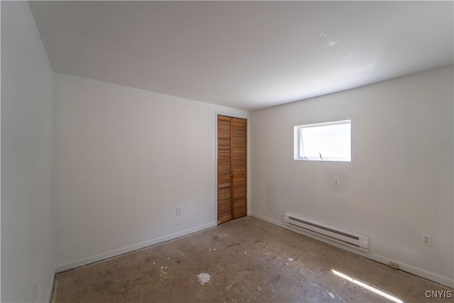 spare room featuring baseboard heating and baseboards