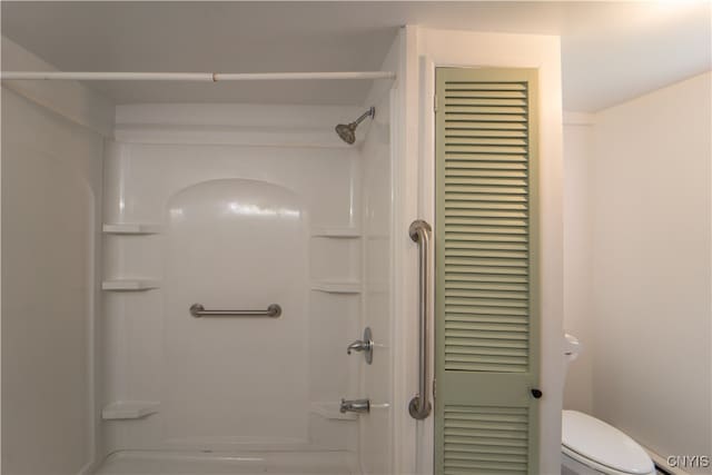 full bathroom with a closet, walk in shower, and toilet