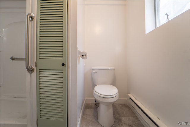 bathroom featuring a closet, a baseboard radiator, toilet, and baseboards