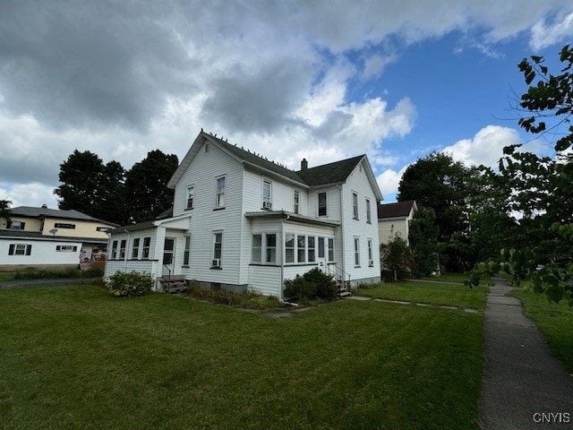 view of home's exterior with a yard