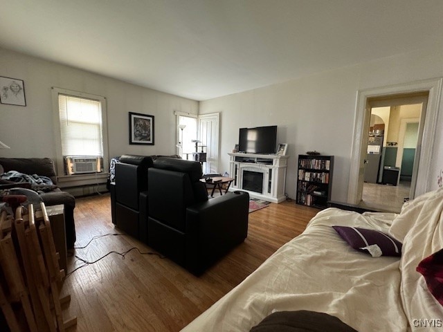 living room with cooling unit and light hardwood / wood-style floors