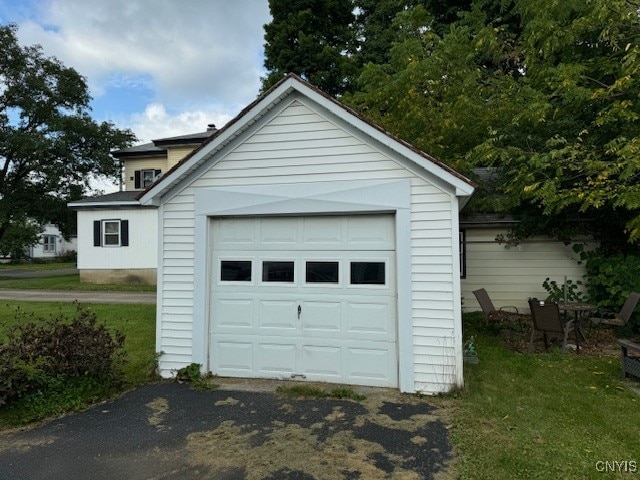 garage featuring a lawn