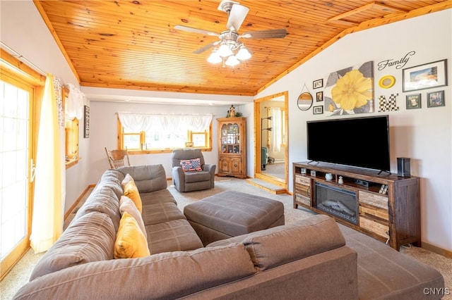 living room with baseboards, lofted ceiling, wood ceiling, ceiling fan, and carpet flooring