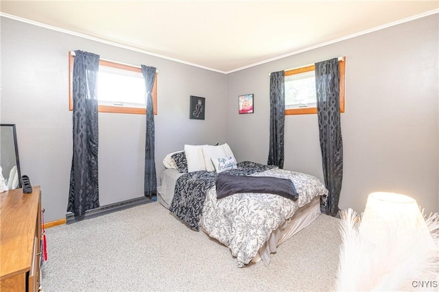 bedroom with multiple windows, ornamental molding, and carpet flooring