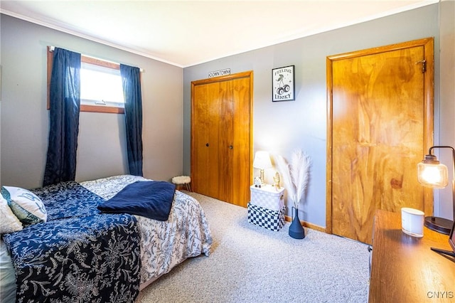 bedroom featuring ornamental molding, carpet flooring, and baseboards