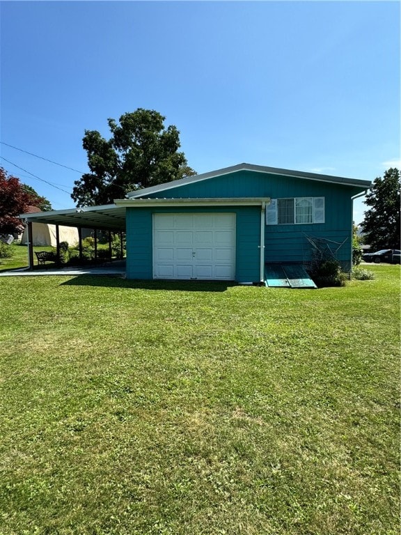 garage with a carport and a yard