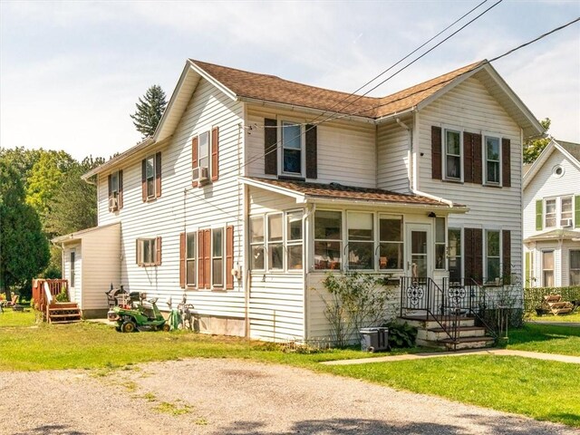 view of front of house featuring a front lawn and central air condition unit