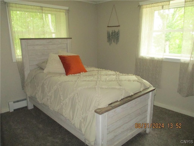 bedroom with carpet flooring, baseboards, and a baseboard heating unit