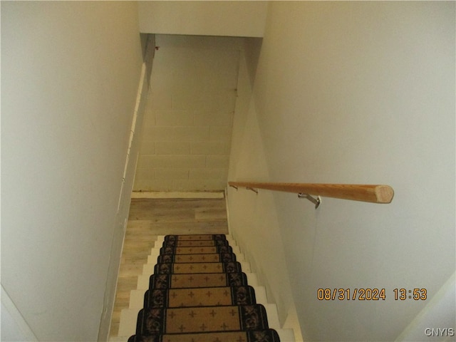 staircase with wood-type flooring