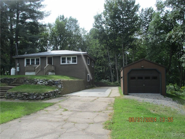 ranch-style home with an outbuilding, a front yard, and a garage