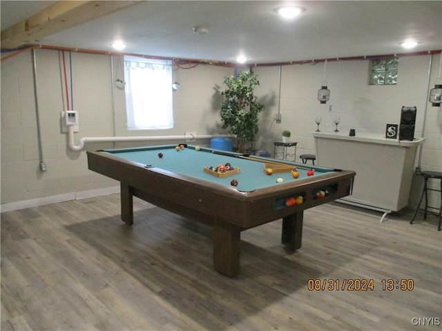 recreation room featuring concrete block wall, wood finished floors, and billiards