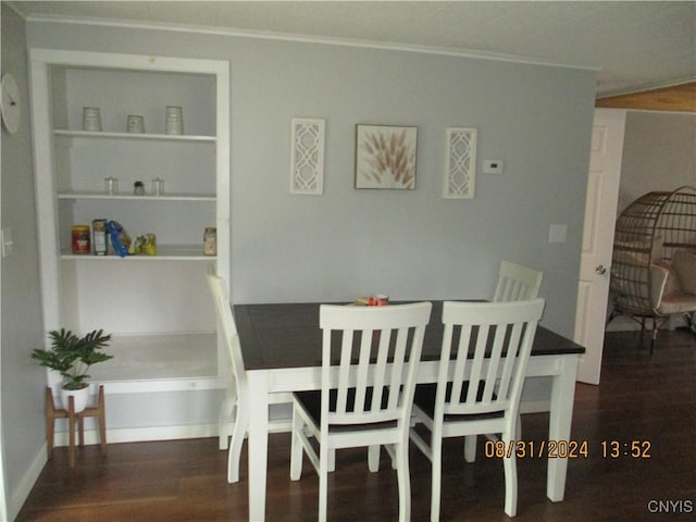 dining room with ornamental molding, built in features, and wood finished floors