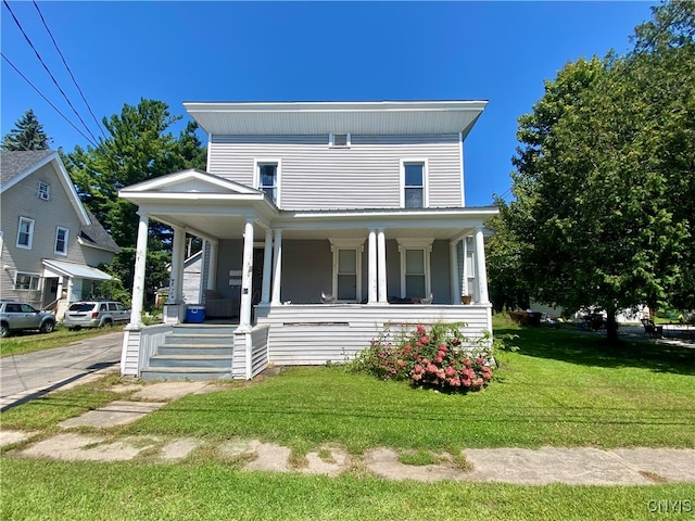 view of front of property with a front yard and covered porch