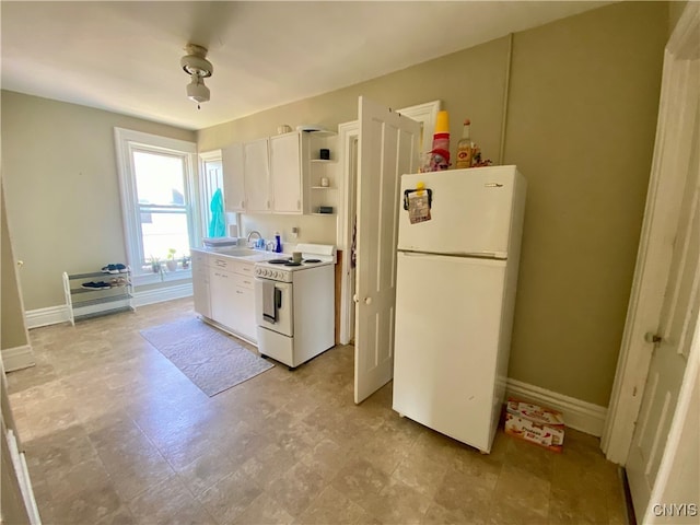 kitchen featuring white cabinets, white appliances, sink, and light tile patterned flooring