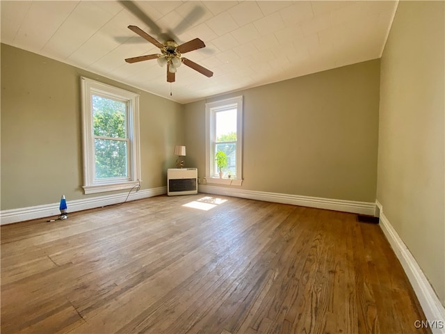 empty room with dark wood-type flooring and ceiling fan