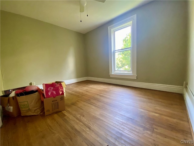 empty room featuring hardwood / wood-style floors and ceiling fan