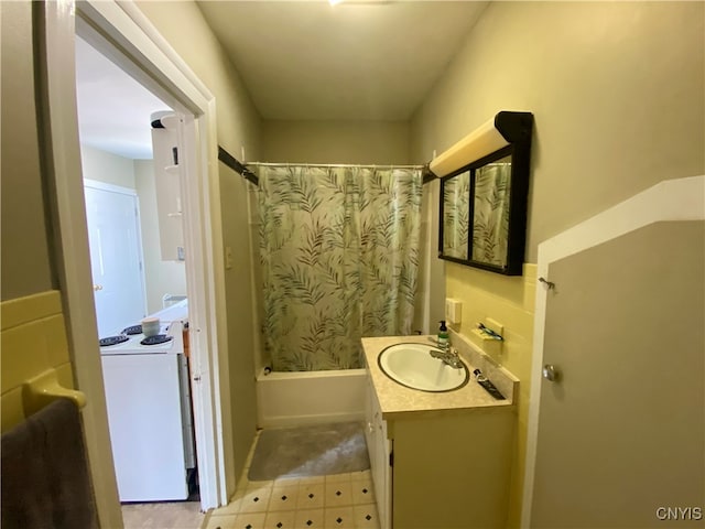 bathroom with washer / dryer, vanity, shower / bath combination with curtain, and tile patterned floors