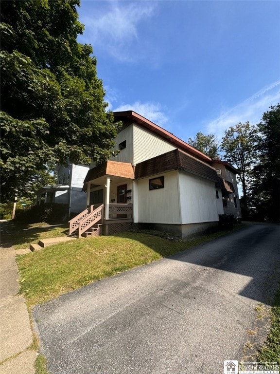 view of property exterior with a yard