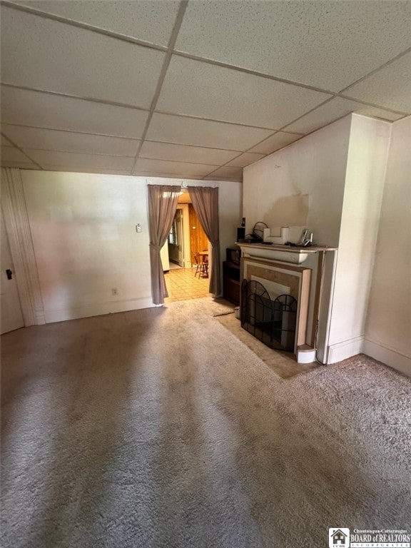 unfurnished living room featuring a paneled ceiling