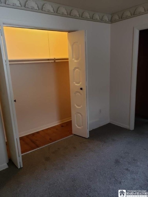 unfurnished bedroom with a closet and carpet floors