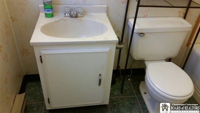 bathroom featuring vanity, toilet, and tile patterned flooring