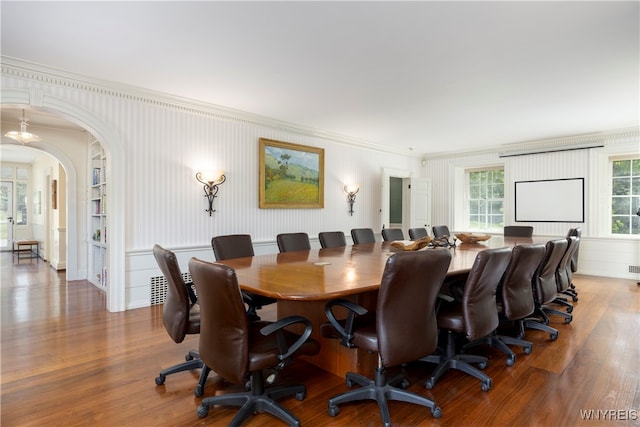 dining area with crown molding and hardwood / wood-style flooring