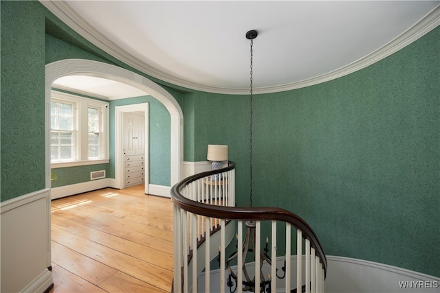 interior space featuring ornamental molding and hardwood / wood-style flooring