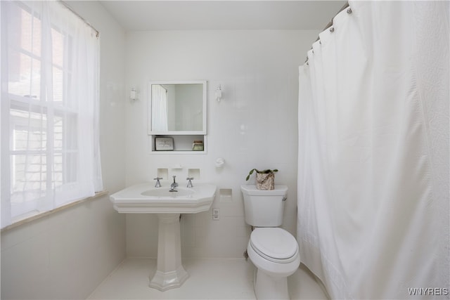 bathroom featuring toilet and tile patterned floors