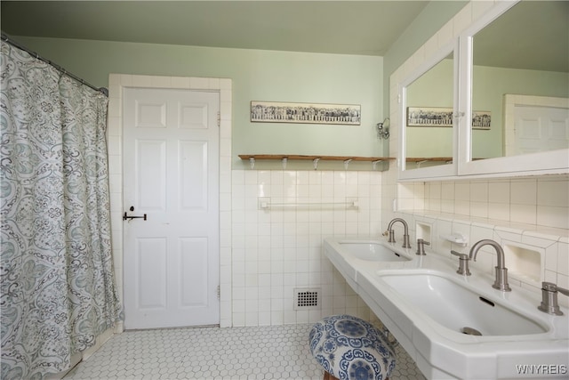 bathroom featuring tile walls, sink, and tile patterned floors