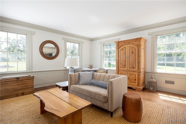 living room featuring hardwood / wood-style flooring and ornamental molding