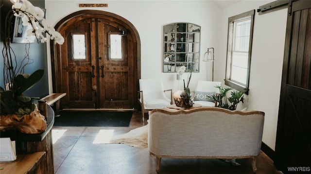 entrance foyer featuring a barn door and tile patterned floors