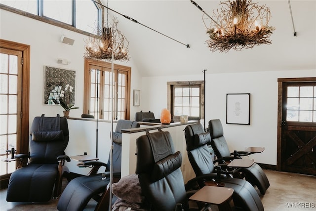 miscellaneous room with an inviting chandelier and concrete floors