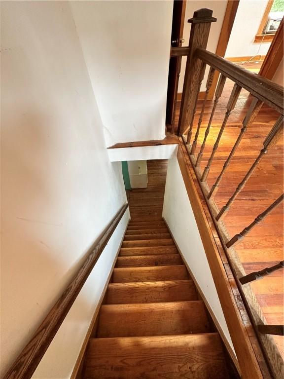 staircase featuring wood finished floors