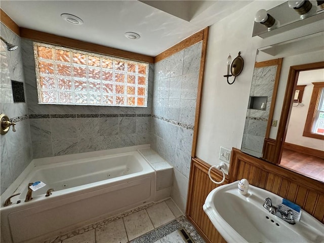 full bathroom featuring tile patterned flooring, a healthy amount of sunlight, and a sink