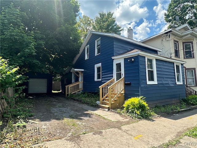 view of front facade featuring an outbuilding and a garage