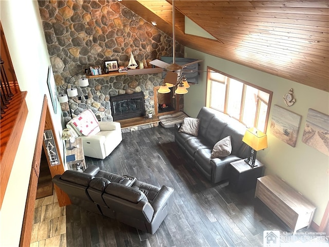 living room featuring ceiling fan, vaulted ceiling, wooden ceiling, a fireplace, and hardwood / wood-style floors