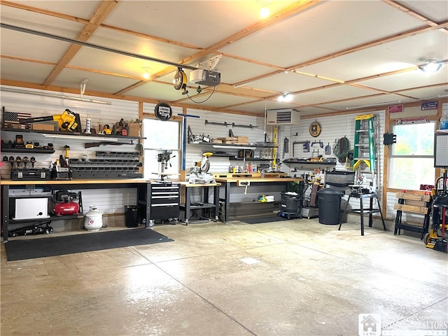 garage featuring a garage door opener and a workshop area