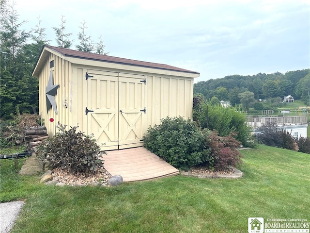 view of outbuilding with a yard