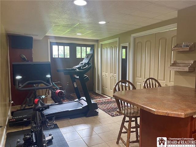 exercise room with light tile patterned floors