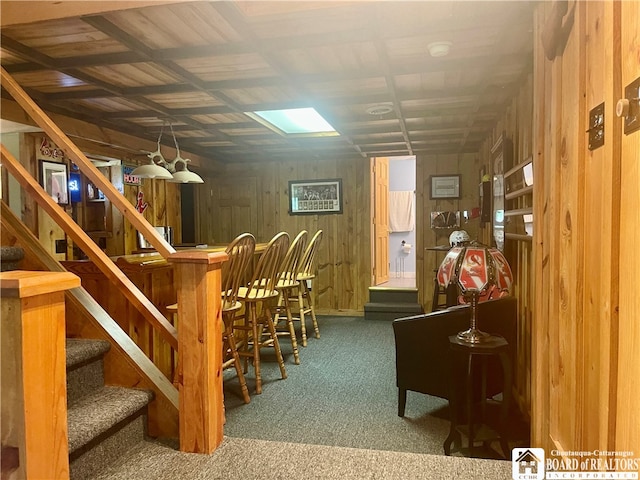 interior space with wood walls and dark carpet