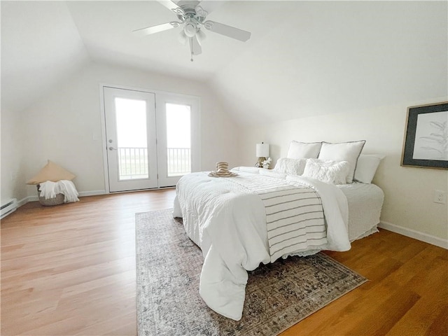 bedroom with ceiling fan, vaulted ceiling, light wood-type flooring, and access to exterior