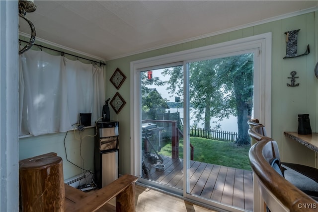 entryway featuring a water view, hardwood / wood-style floors, and ornamental molding