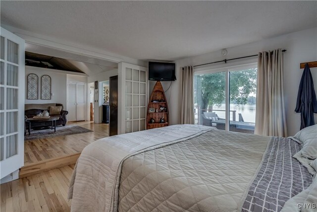 bedroom featuring french doors, access to exterior, and light hardwood / wood-style floors