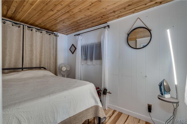 bedroom featuring wood ceiling and light hardwood / wood-style floors