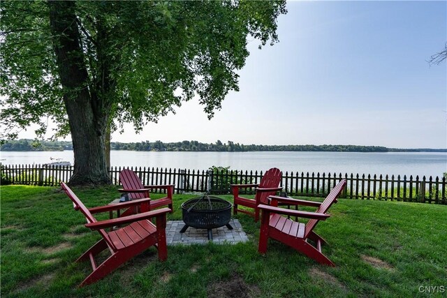 view of yard with a fire pit and a water view