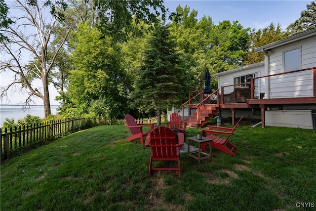 view of yard with a deck with water view